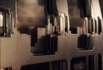 Abstract of steel sheets with areas stamped out.